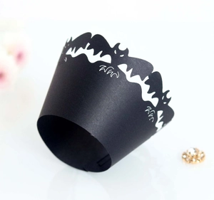 Detail of laser-cut black bat cupcake wrappers for Halloween party decoration