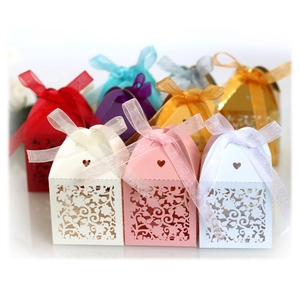 Assorted laser-cut flower candy boxes with organza ribbons for wedding favors