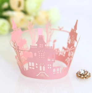 Macro shot of laser-cut pink cupcake wrapper featuring castle and haunted house designs