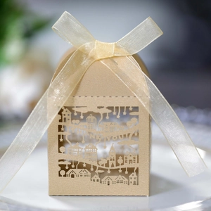 Close-up of laser-cut Thank You kraft candy box with architectural hollow and satin ribbon