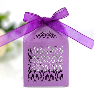 Detail of purple laser-cut gift box featuring intricate floral patterns and a ribbon bow