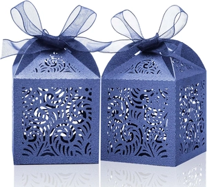 Laser-cut navy blue favor boxes with floral pattern and matching organza ribbon bows