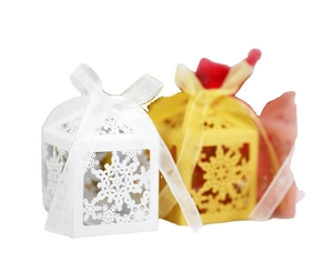 Laser cut gift box with snowflake pattern and ribbon bow for wedding and Christmas candy