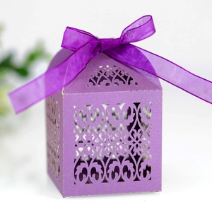 Detailed laser-cut purple gift box with intricate vine patterns and matching silk ribbon