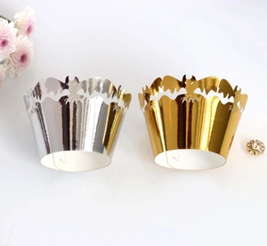 Close-up of gold and silver laser-cut bat cupcake wrappers for Halloween party decor