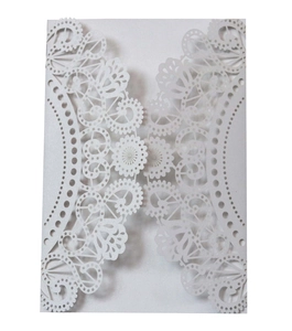 Detailed laser-cut pattern and lace texture on white pearlescent wedding card cover