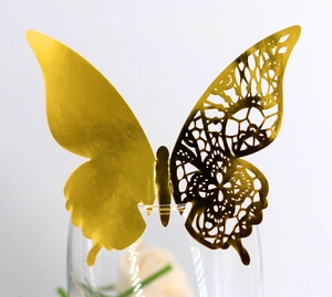 Detailed macro view of a gold 3D butterfly glass card with laser cut geometric patterns