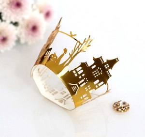 Detailed laser-cut gold cupcake wrapper featuring Halloween castle and pumpkin motifs