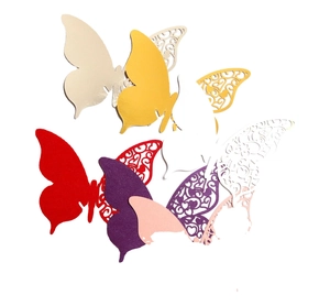 Assorted hollow-out butterfly place cards in gold, red and purple for wedding wine cups