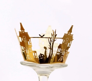 Golden laser-cut Halloween cupcake wrappers with castle, pumpkin, and bat silhouettes