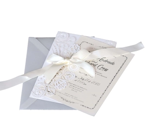 Detailed laser-cut lace invitation set with silver reflective paper and ivory satin bow