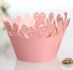 Detailed laser-cut pink peacock lace cupcake wrapper for elegant wedding cake decoration