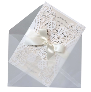 Laser cut lace wedding invitation with ribbon bow and translucent frosted envelope set