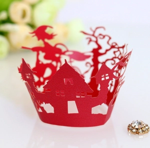 Close-up of red laser-cut cupcake wrapper featuring Halloween witch and haunted house