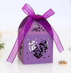 Close-up of laser-cut purple gift box with LOVE heart pattern and matching organza ribbon