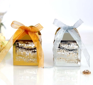 Close-up of laser-cut Thank You gift boxes with metallic finish and organza ribbons