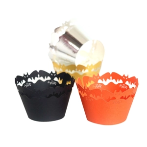 Halloween cupcake wrappers with hollow bat designs in black, orange, and metallic gold