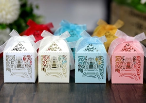 Detailed laser-cut gift boxes with Eiffel Tower patterns and ribbons in multiple colors