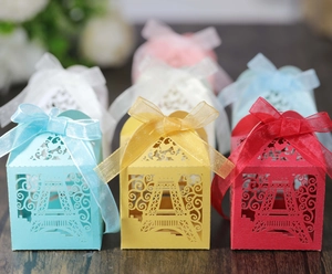 Detailed laser-cut Eiffel Tower favor boxes with elegant silk ribbons in multiple colors