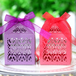 Detailed laser cut floral hollow paper gift boxes with elegant ribbon bows for weddings