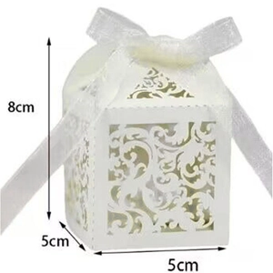 Detail view of white laser-cut wedding favor box with dimensions 8cm by 5cm