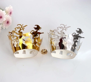 Laser-cut Halloween cupcake wrappers in gold and silver with witch and tombstone designs
