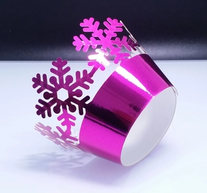 Magenta metallic cupcake wrapper with laser-cut snowflake patterns for Christmas decor