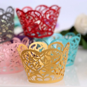 Laser-cut cupcake wrappers with elegant vine patterns in various metallic colors