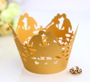 Laser-cut gold cupcake wrapper featuring romantic couple silhouette and heart-shaped patterns
