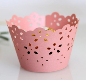 Pink laser-cut floral cupcake wrappers for wedding decorations and party desserts