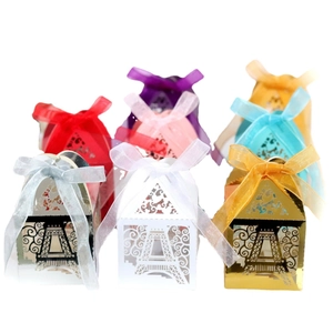 Golden Eiffel Tower laser cut candy boxes with hollow heart design and ribbon bows