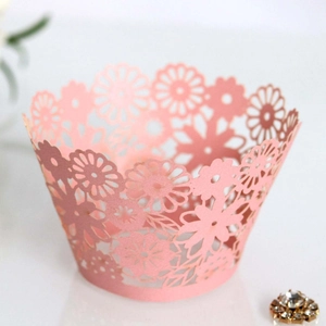Pink laser-cut cupcake wrappers with daisy floral patterns for holiday cake decoration