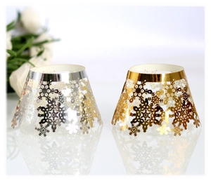 Detail of laser-cut snowflake patterns on gold and silver festive cupcake wrappers