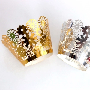 Laser-cut floral cupcake wrappers in metallic gold and silver for party decoration