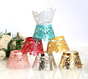 Macro shot of laser-cut snowflake cupcake wrappers in various pearlescent colors