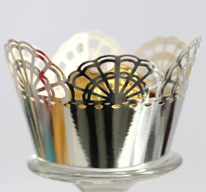 Macro shot of high-shine silver mirror cupcake liners with laser-cut lace patterns