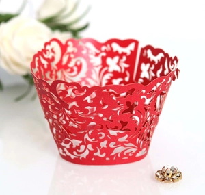Elegant laser-cut red lace cupcake wrappers with intricate floral patterns for party decor