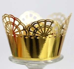 Close-up of golden crown laser cut cupcake wrapper for wedding and party decoration