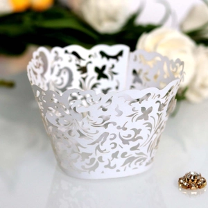 Elegant white laser-cut cupcake wrappers with floral patterns for wedding party decor