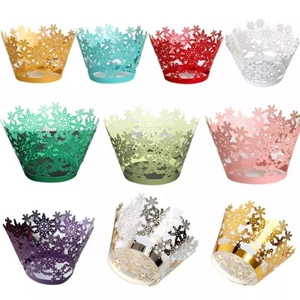 Laser-cut snowflake cupcake wrappers in various metallic colors for Christmas party decor