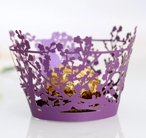 Deep purple laser-cut cupcake wrappers with floral patterns and gold chocolate display