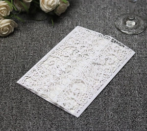 Detailed laser-cut hollow floral pattern on elegant white wedding invitation card