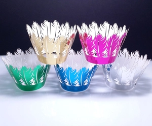 Five-color laser-cut feather cupcake wrappers in metallic gold, magenta, green, blue, and silver