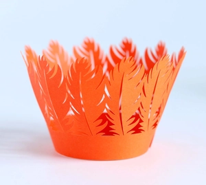 Laser cut feather design cupcake wrapper in bright orange for festive party decoration