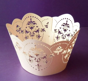 Detailed laser-cut hollow floral pattern cupcake wrappers in elegant ivory color