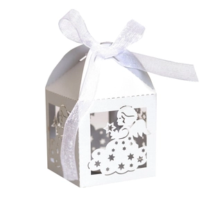 Close-up of laser-cut white angel candy box with stars and white ribbon bow detail