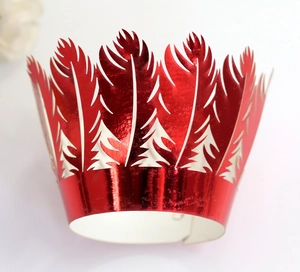 Macro view of metallic red laser-cut cupcake wrappers with festive tree patterns