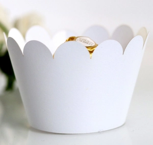 Close-up of a minimalist white scalloped paper cupcake liner for dessert decoration