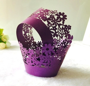 Close-up of laser-cut floral pattern on deep purple pearlescent cupcake wrappers