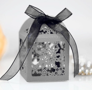 Elegant laser-cut snowflake gift box in silver grey with a black organza ribbon bow